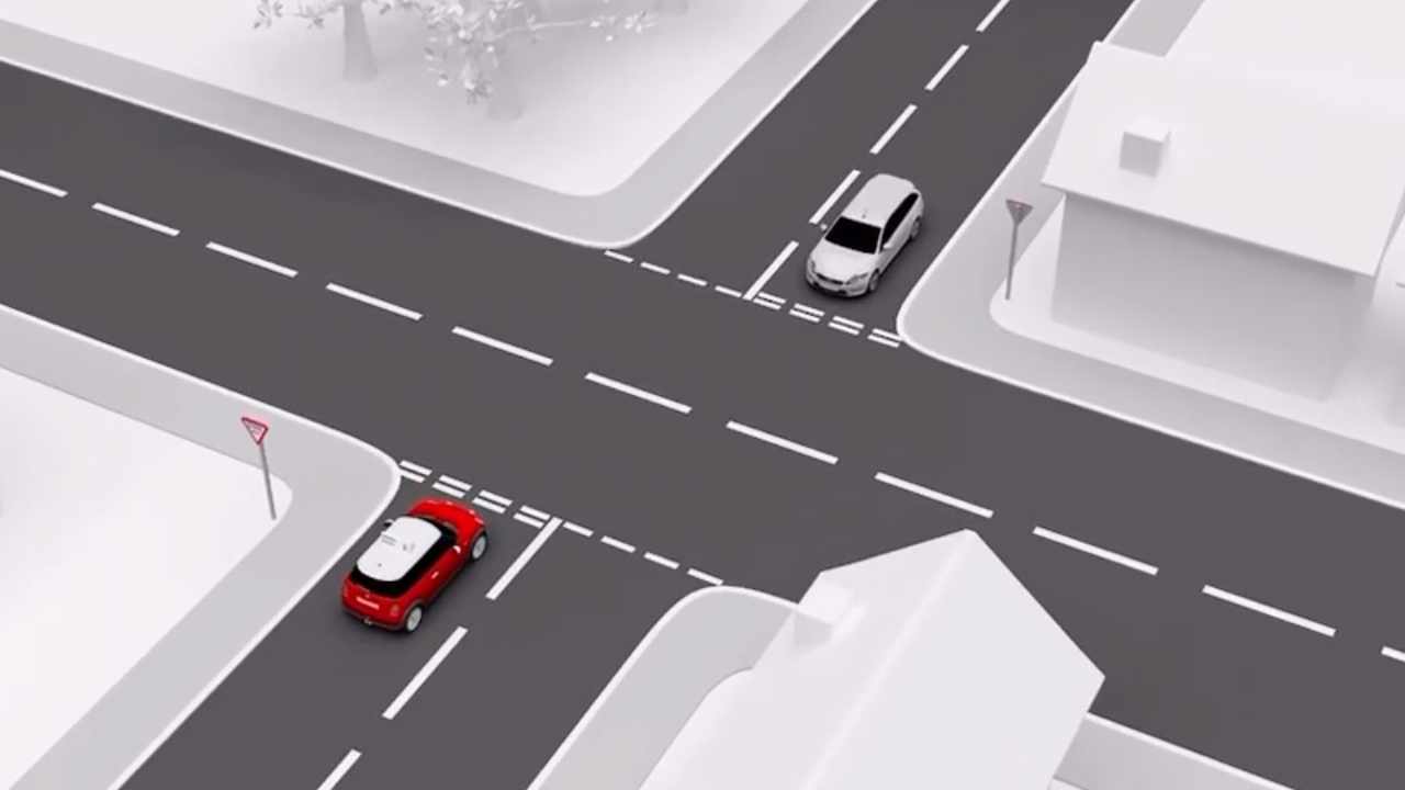 Cross Roads with a Car emerging and Following the Road Ahead